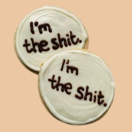 Two round cookies with text 'I'm the shit' on a beige background