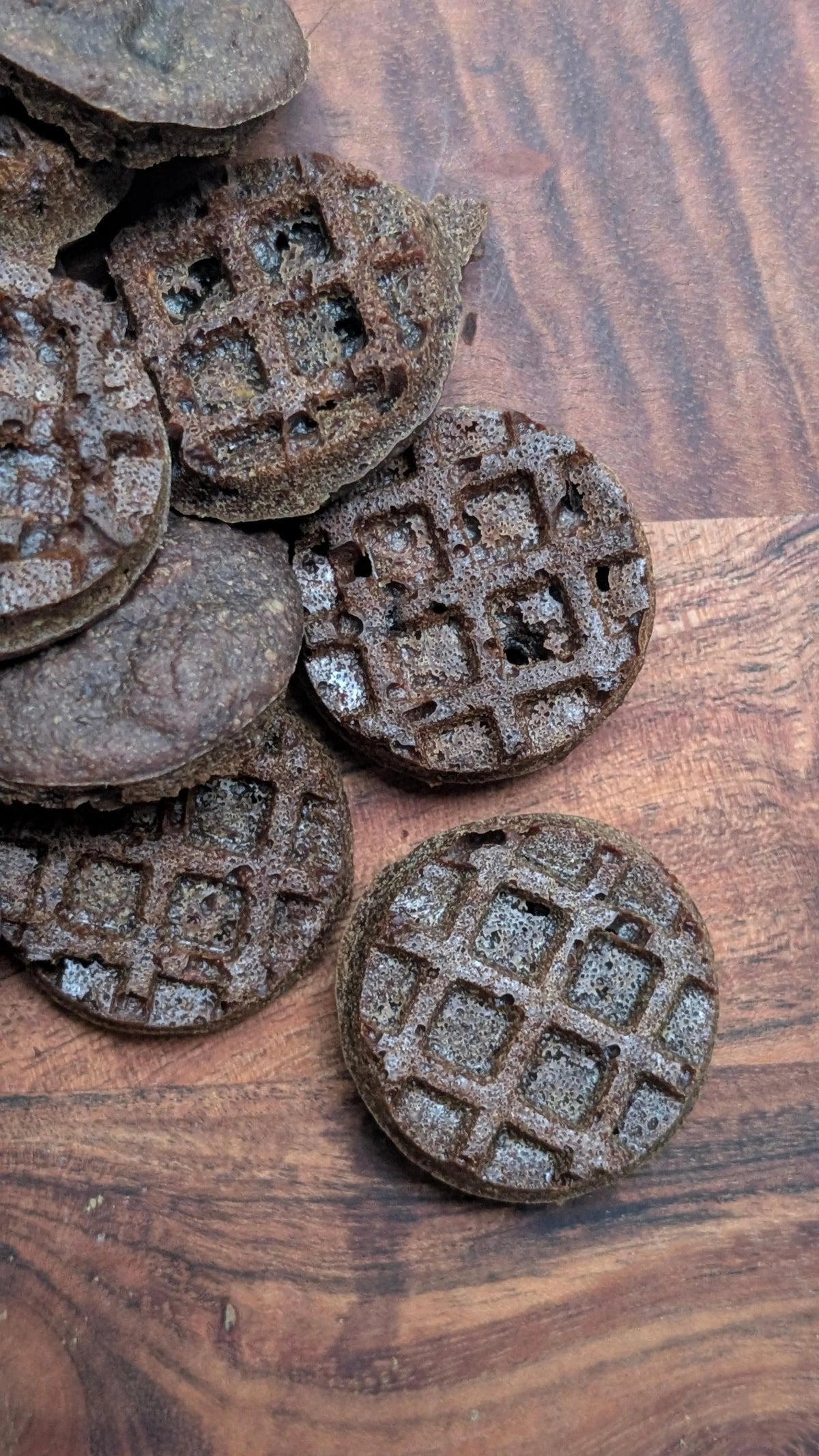 Pets Paradise Love triple berry waffle dog treats with glucosamine on a wooden surface