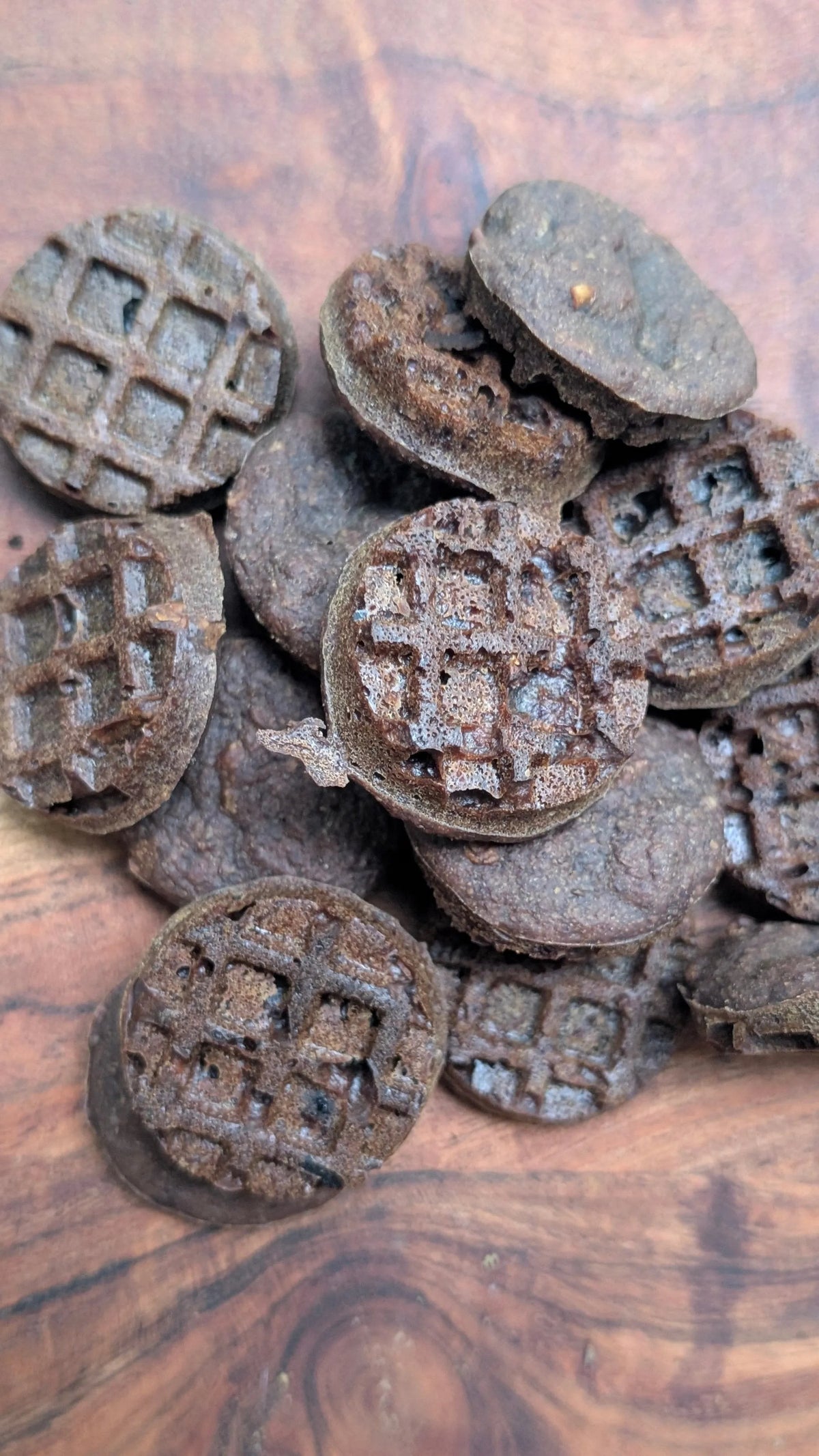 Pets Paradise Love triple berry waffle dog treats with glucosamine, featuring a dark, round, grid-patterned texture.
