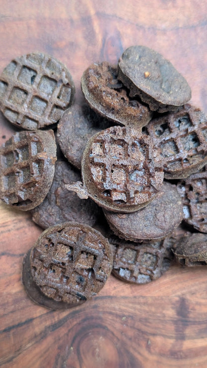 Pets Paradise Love triple berry waffle dog treats with glucosamine, featuring a dark, round, grid-patterned texture.