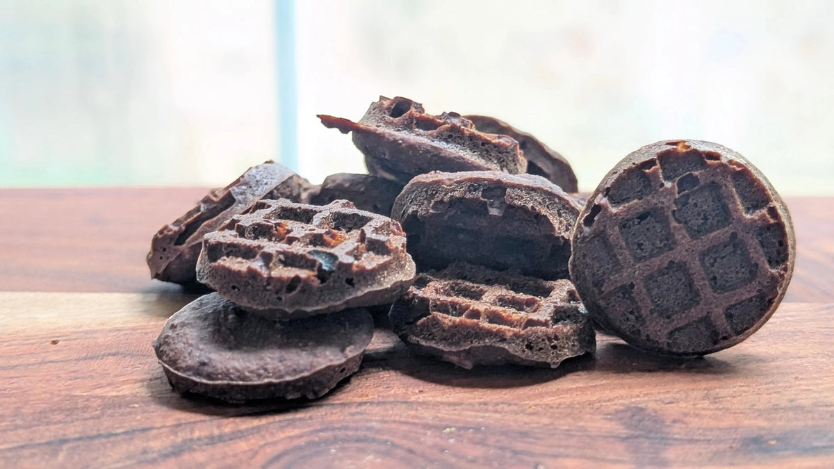 Pets Paradise Love triple berry waffle dog treats with glucosamine, featuring a dark, nutrient-dense waffle texture.
