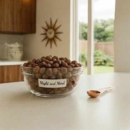 Pets Paradise Love Might and Mind dog treats in a glass bowl on a kitchen counter with a measuring spoon